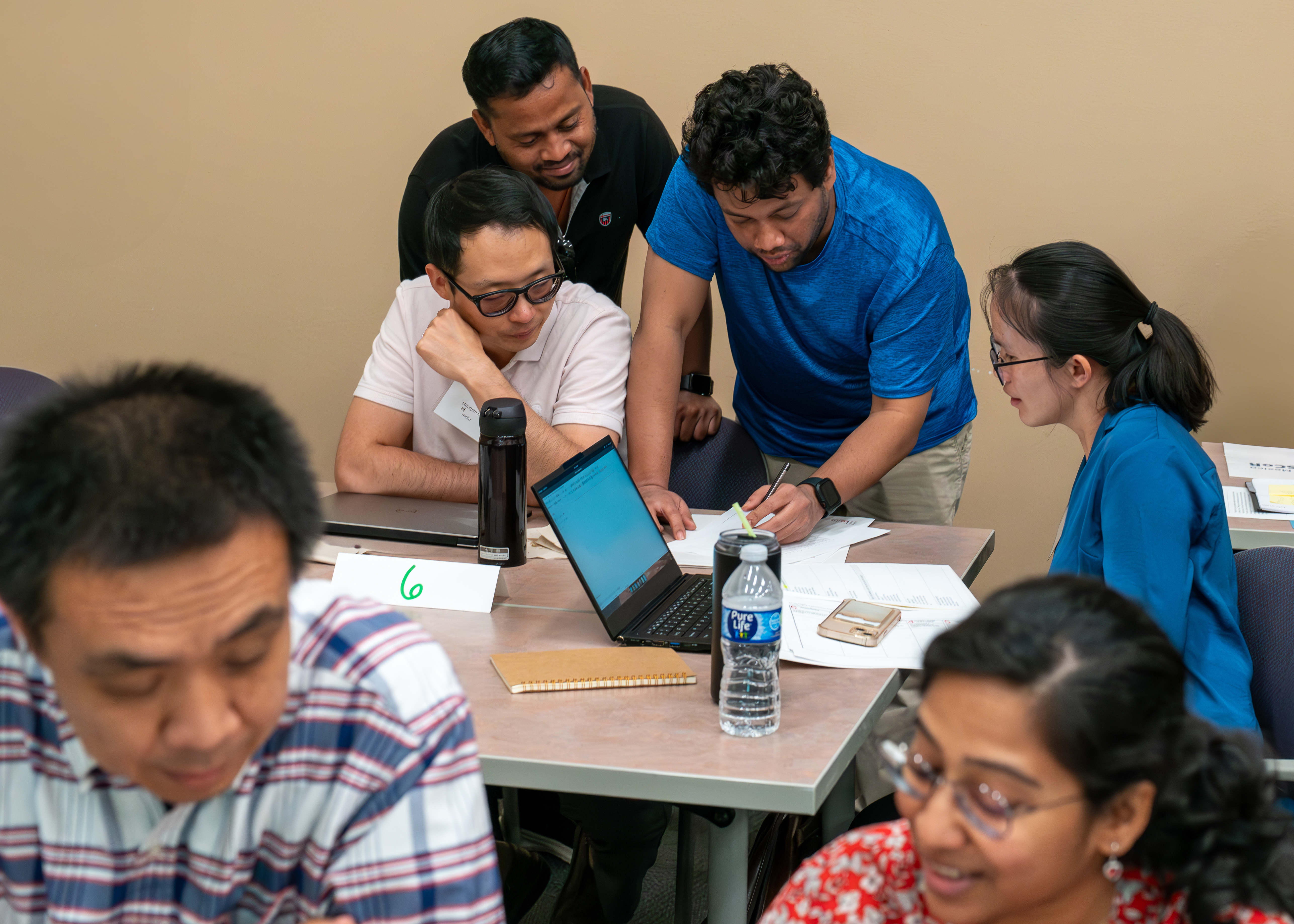 group of researchers working together at tables