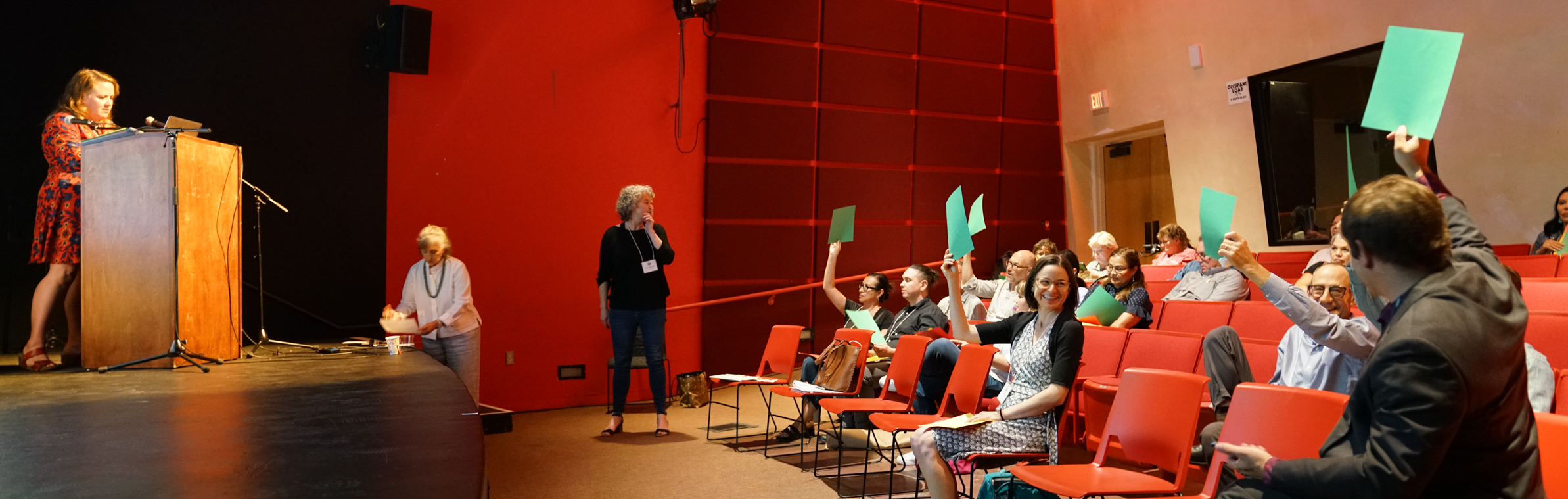 people holding up pieces of colored paper