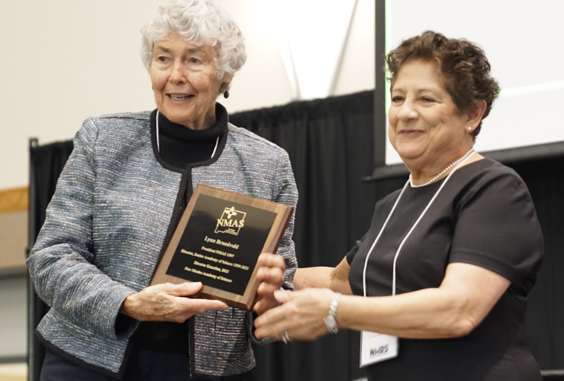 two women holding an award