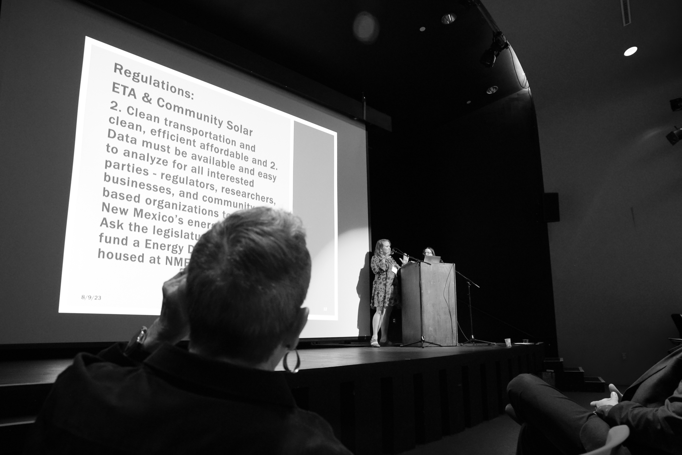 woman talking at lectern on stage