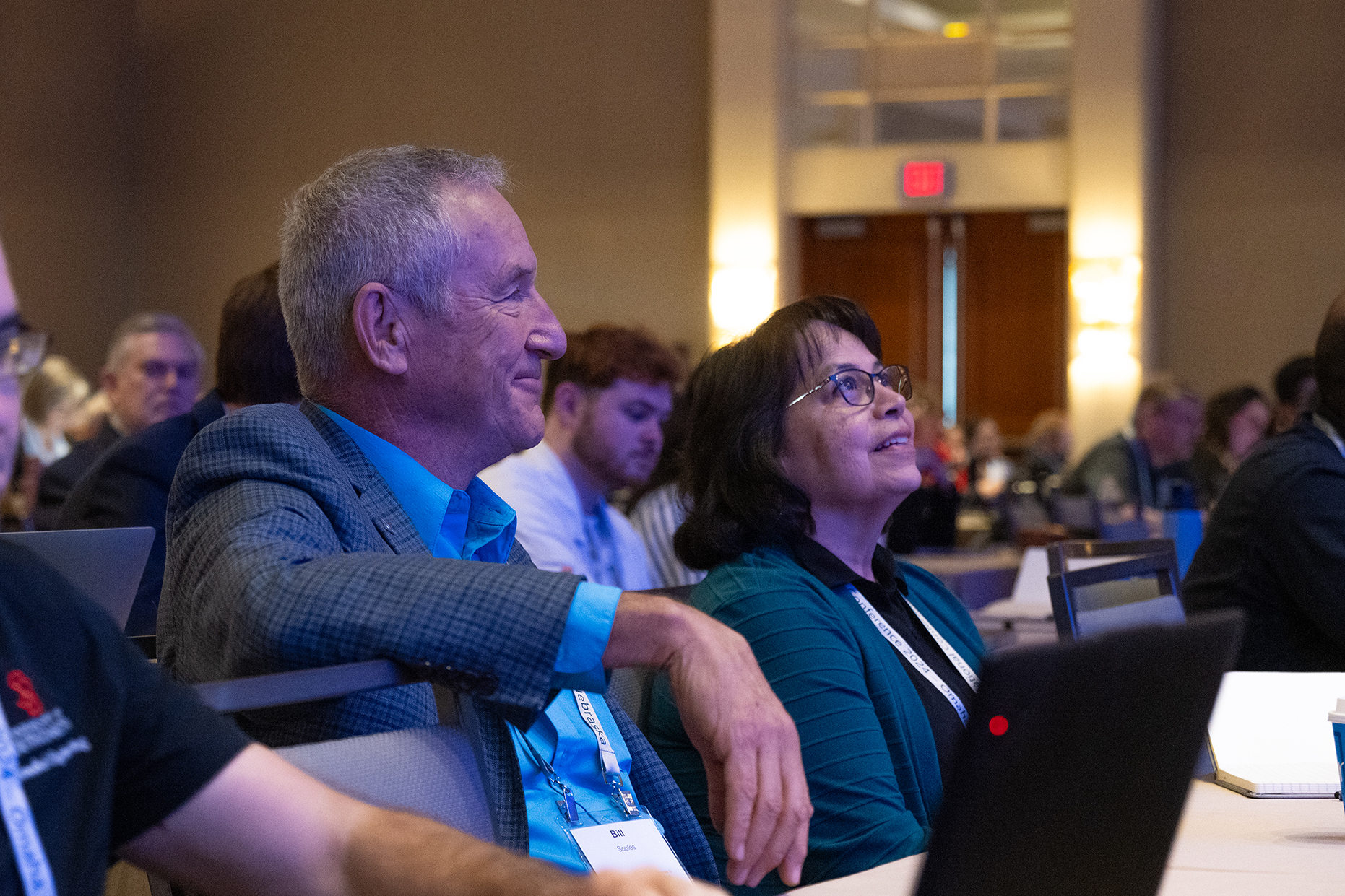 Two people in profile intently looking forward